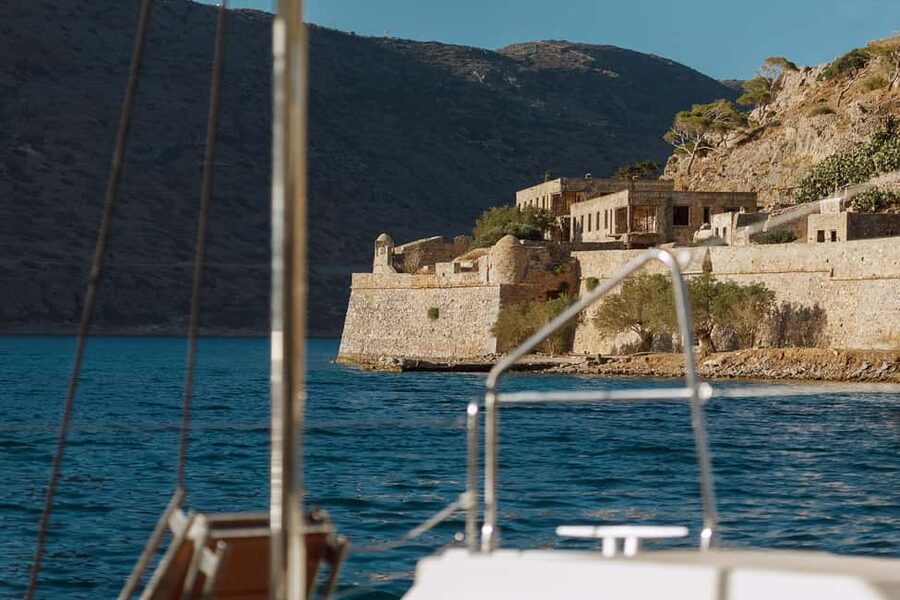 Agios Nikolaos All-inclusive Catamaran Cruise & Water Toys - Sailing past Barbarossa Cave and Spinalonga