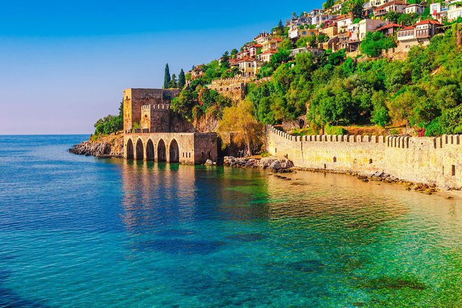 Alanya Catamaran Boat Tour with Sunbathing Swimming & Snorkelling - Seeing the Red Tower, Old Shipyard, and castle from the water
