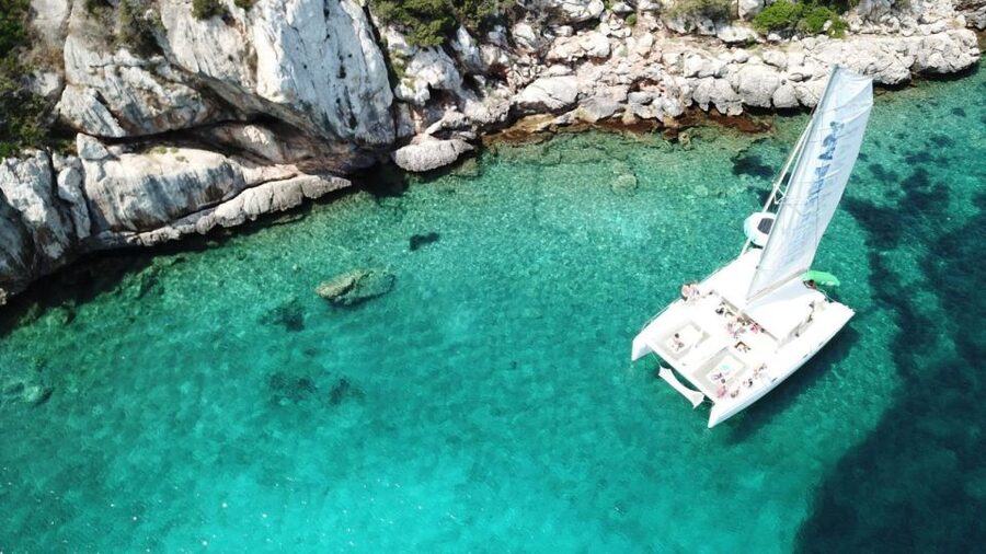 Alghero: Full day on a catamaran in Porto Conte Natural Park - Leaving from Marina di Porto Conte