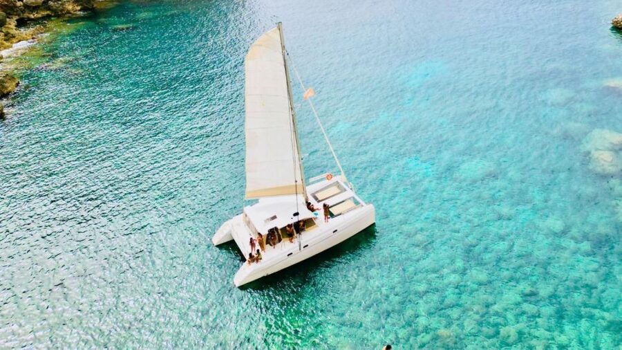 Alghero: Full day on a catamaran in Porto Conte Natural Park - Sailing beneath Capo Caccia