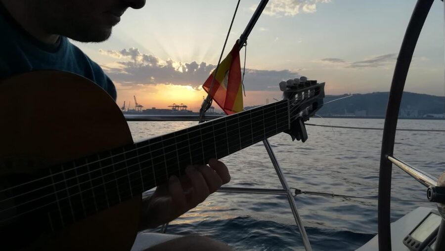 Barcelona: Sunset Sailing with Live Guitar Music and Tapas - Spanish guitar with the city behind you