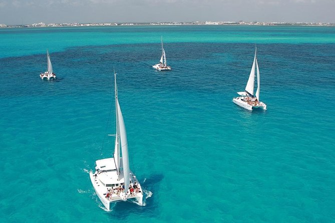 Catamaran adventure to Isla Mujeres with Snorkel,Buffet,Open Bar and Beach Club - Return sailing, photographs, and the party-boat finish