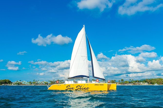 Catamaran Cruise Full Day Tour to Reef, Caves and Negril Beach - Passing Rick’s Cafe at sunset