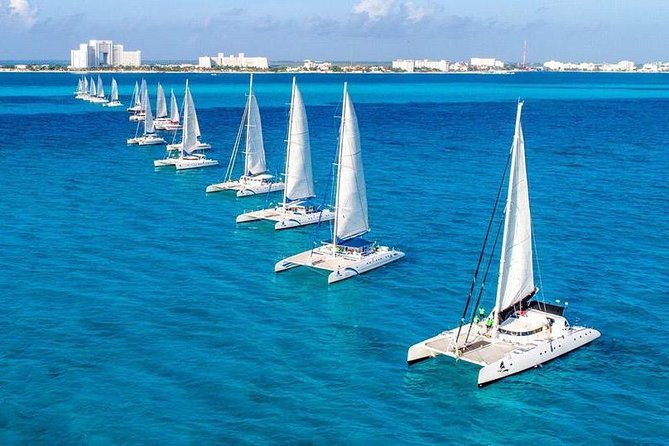 Catamaran Sail to Isla Mujeres with all inclusive from Cancun or Riviera Maya - Golf carts and the island beyond the beach