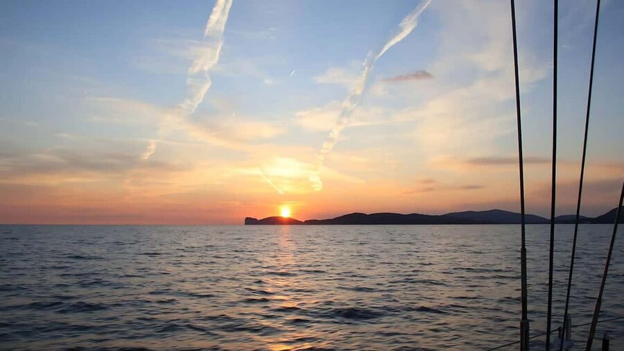 From Alghero: sunset on a sailing boat with aperitif - Capo Caccia in the last light