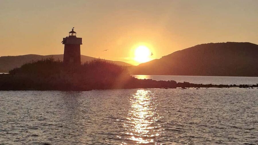 From Alghero: sunset on a sailing boat with aperitif - La Maddalenetta Island and the open-water views