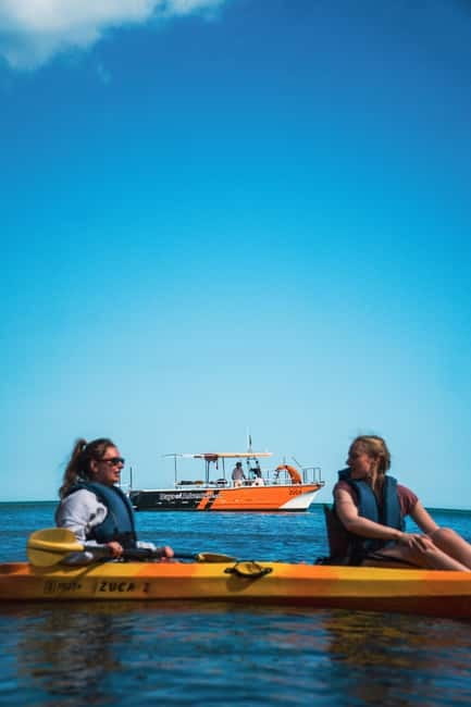 From Lagos: Ponta da Piedade Caves Kayak Tour from Catamaran - Sliding into a kayak beneath the arches