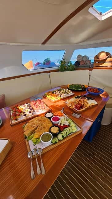From Palma: Luxury Catamaran Group Tour with Tapas & Drinks - Daytime versus the two-hour evening option