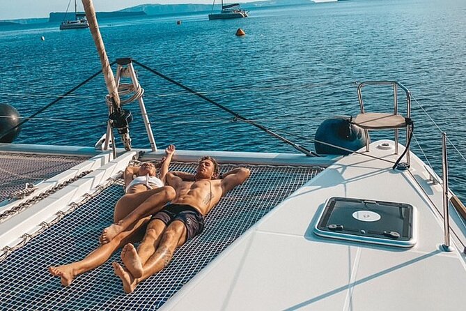 Half-Day Exclusive Catamaran Cruise in Santorini with Meal and Open Bar - The lighthouse and the volcanic caldera