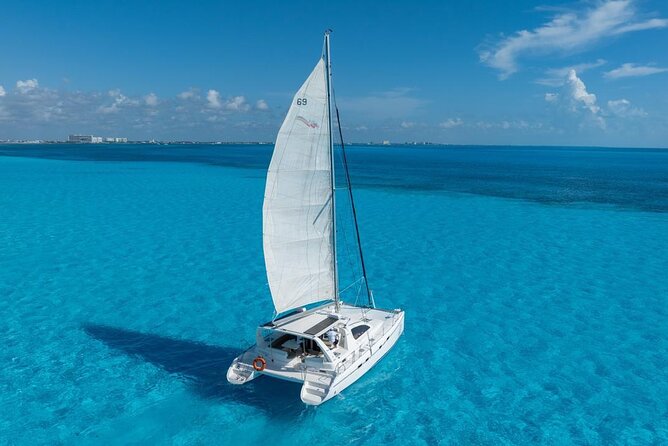 Isla Mujeres Day Tour with Catamaran, Snorkeling & Beach Club - Sailing into Bahia Mujeres for the reef stop