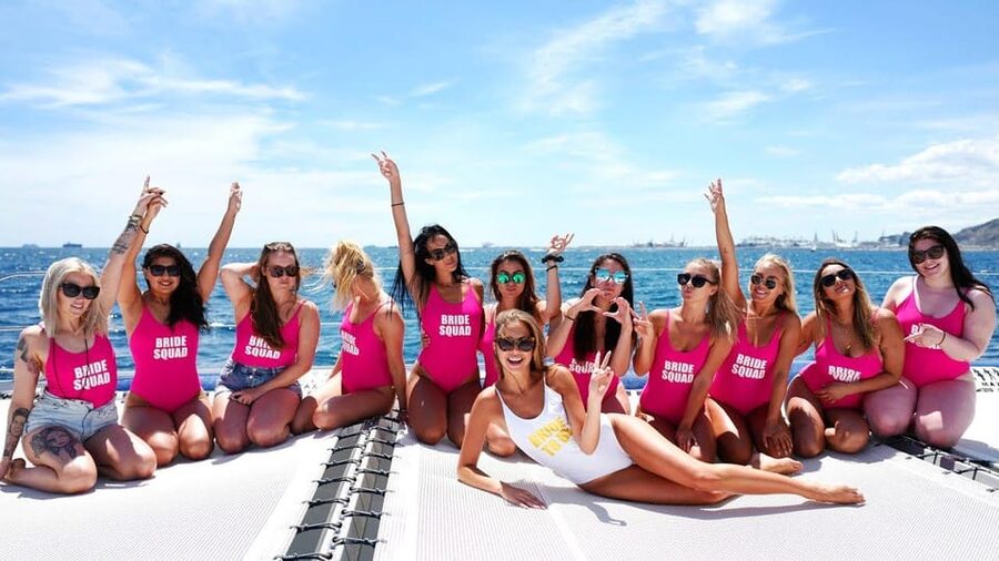 Lisbon: Catamaran Boat Party with Music, Open Bar & Dives - A party boat with Lisbon as the backdrop