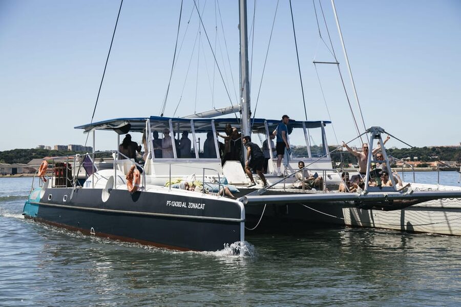 Lisbon: Catamaran Boat Party with Music, Open Bar & Dives - Cruising toward Algés