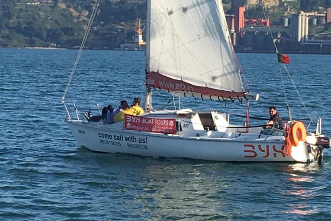 Lisbon Sunset Sailing Tour with White or Rosé Wine and Snacks - Sunset, wind, and the small-boat reality