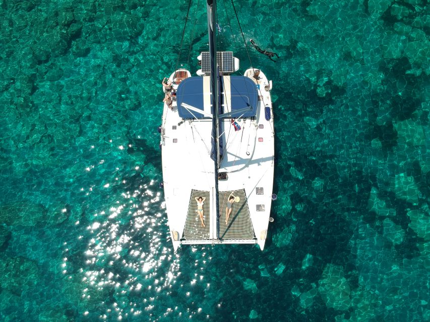 Milos: Full-Day Catamaran Cruise with Paddle Board - Leaving Adamas past ancient Milos