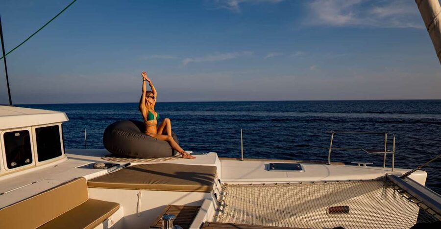 Mykonos: Boho Experience Catamaran Cruise - Rhenia swimming and the clear-water stop