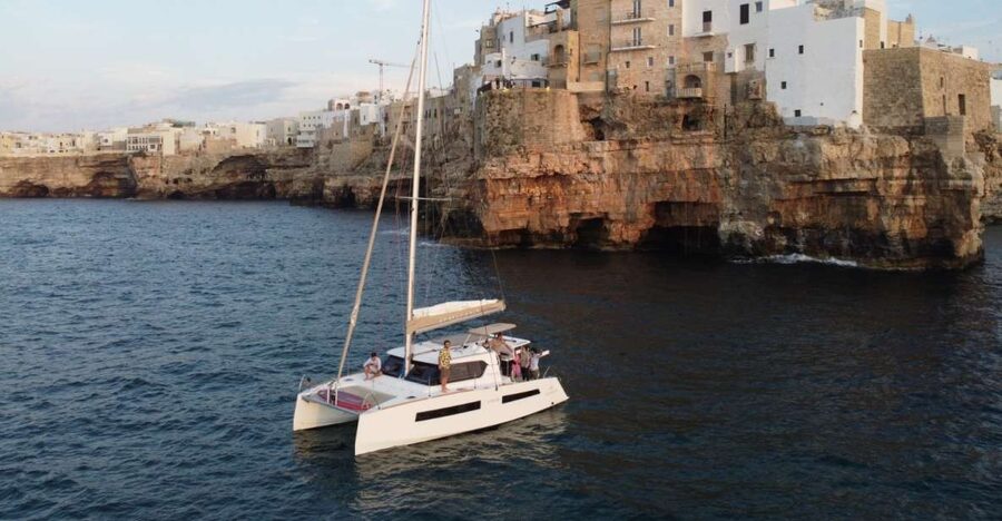 Polignano a Mare: Catamaran Tour with Aperitif & Local Food - Grotta Palazzese and the cave-lined coast