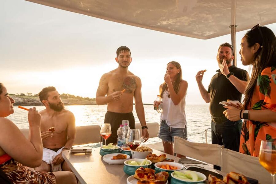 Polignano a Mare: Catamaran Tour with Aperitif & Local Food - Lama Monachile from below the Bourbon bridge