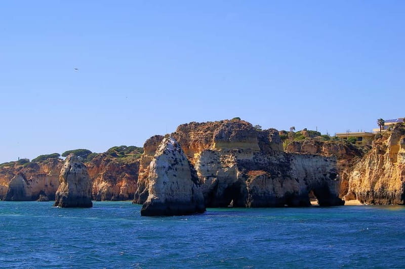 Portimão: Boat Trip by Sailing Boat to Lagos Cape Caves - Lagos harbor, castle, and old shoreline