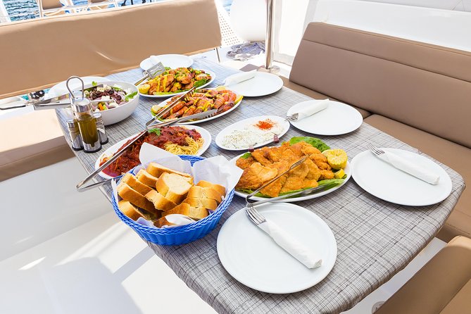 Premium Small-Group Catamaran Cruise with BBQ, Open Bar, Transfer - Thirasia and the caldera towns from below