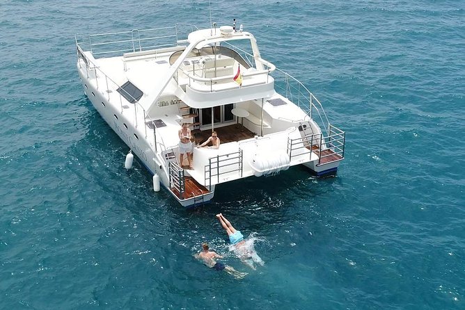 Private Catamaran Charter with Transfer, Buffet and Snorkeling - Swimming and snorkeling in clear coastal water
