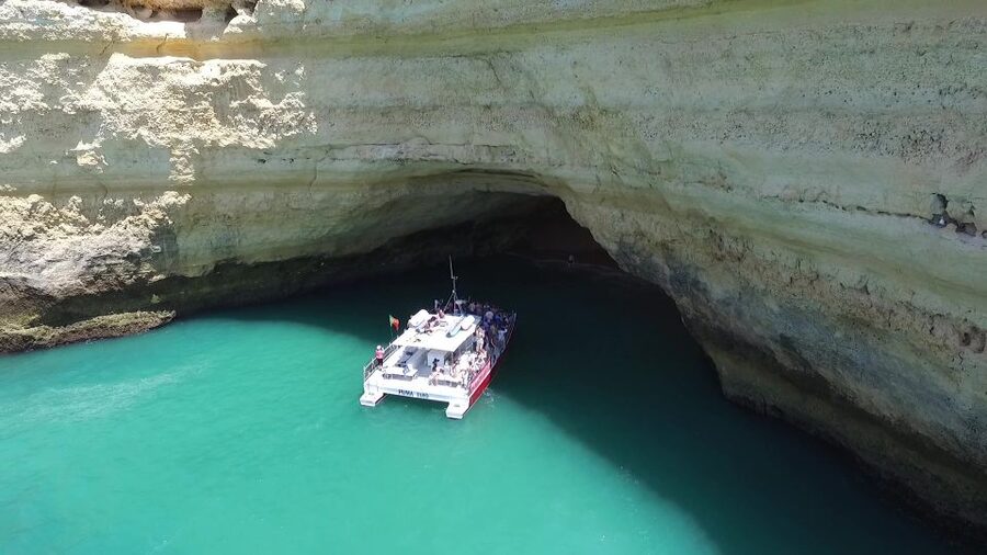 Quarteira: Benagil Cave Guided Catamaran Day Cruise & Drink - Entering Benagil Cave by catamaran