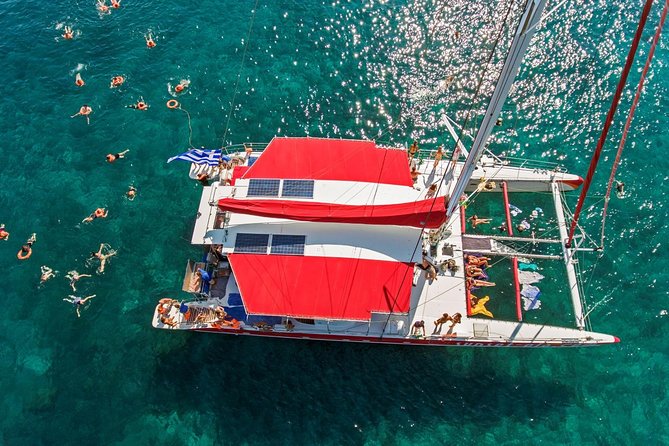 Sailing Catamaran Cruise in Santorini with BBQ, Drinks and Transfer - Leaving Santorini by boat