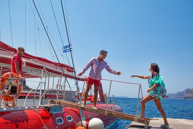 Sailing Catamaran Cruise in Santorini with BBQ, Drinks and Transfer - Red Beach from the sea