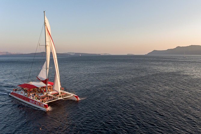 Sailing Catamaran Cruise in Santorini with BBQ, Drinks and Transfer - Sailing past the volcano and Palea Kameni