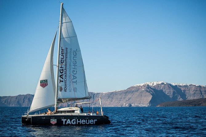 Santorini: Adventurous Catamaran Experience with Snorkeling - Passing Akrotiri Lighthouse