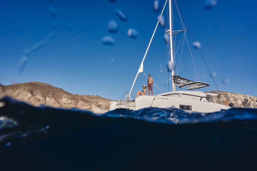 Santorini: Caldera Luxury Catamaran Cruise w/ Meal & Drinks - Red Beach, where the volcanic colors begin
