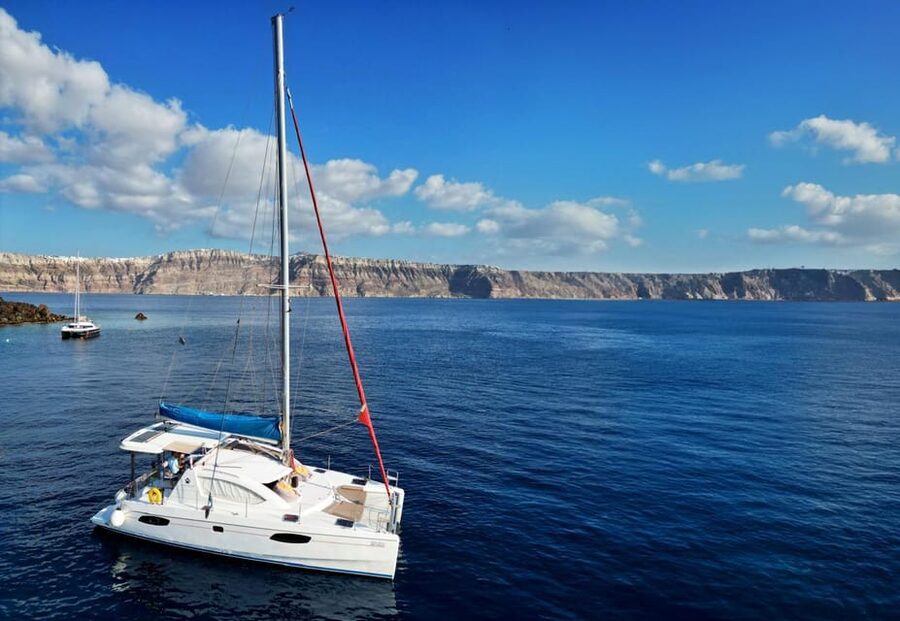 Santorini: Catamaran Cruise with Greek BBQ and Drinks - Red Beach and Santorini’s southern cliffs