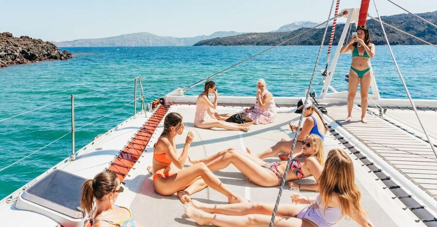 Santorini: Catamaran Tour with BBQ Dinner, Drinks, and Music - Five hours around Santorini by catamaran