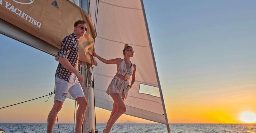 Santorini Gold Catamaran Cruise with Snorkel, BBQ & Open Bar - White Beach, the lighthouse, and Santorini from below