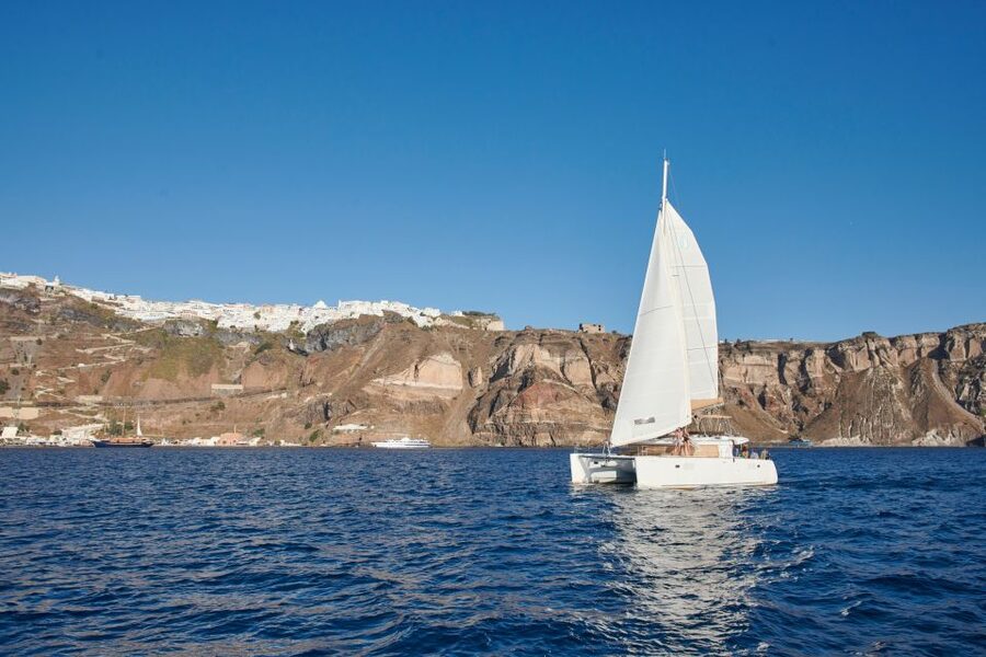 Santorini Gold Catamaran Cruise with Snorkel, BBQ & Open Bar - Caldera cliffs and villages from the water