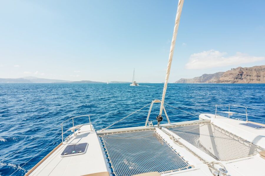 Santorini: Luxury Catamaran Day Trip with Meal and Open Bar - White Beach sea caves and volcanic scenery