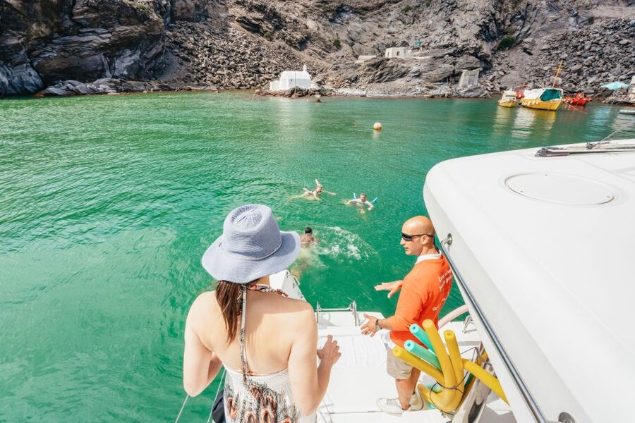 Santorini: Luxury Catamaran Day Trip with Meal and Open Bar - Sunset below Oia, or a calmer daytime departure