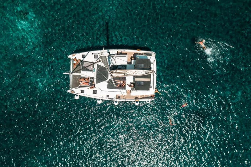 Santorini: Majestic Catamaran Cruise with Meal and Drinks - Volcanic beaches and the hot springs