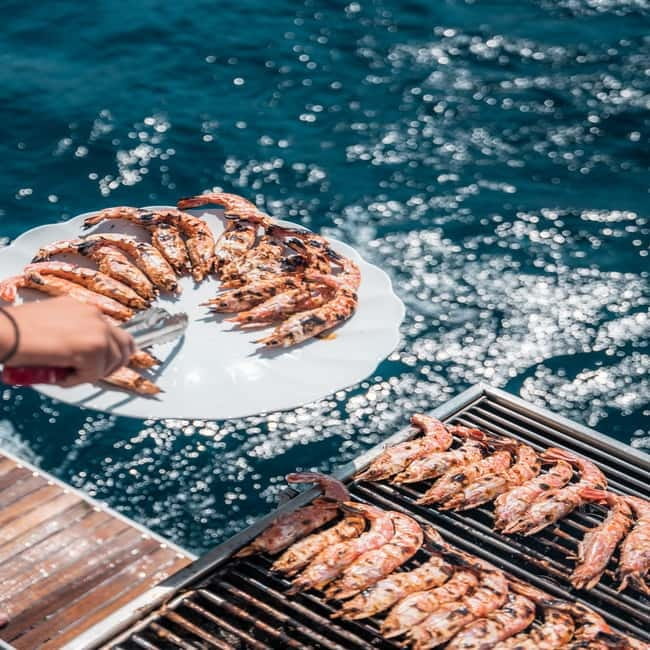 Santorini: Majestic Catamaran Cruise with Meal and Drinks - Red Beach and White Beach from the water