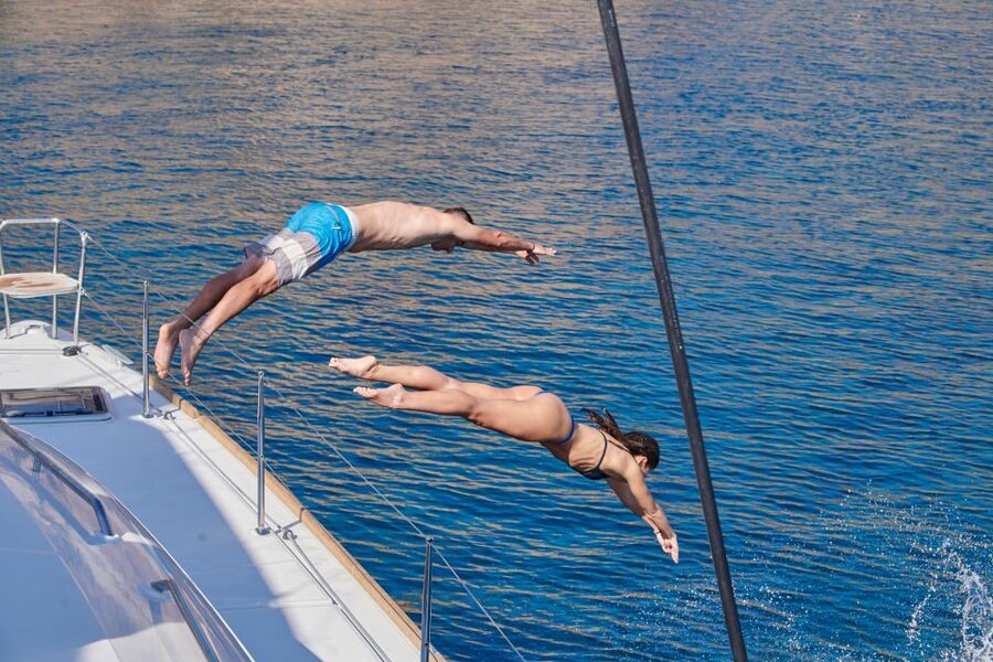 Santorini: Platinum Catamaran Cruise w/ BBQ Meal & Open Bar - Sunset near Akrotiri lighthouse