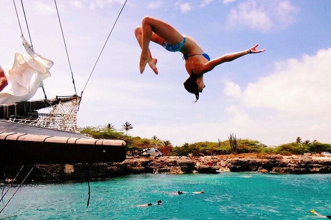Set Sail in Aruba: Jolly Pirate Cruise with Snorkel Adventure - The rope swing supplies the comic relief