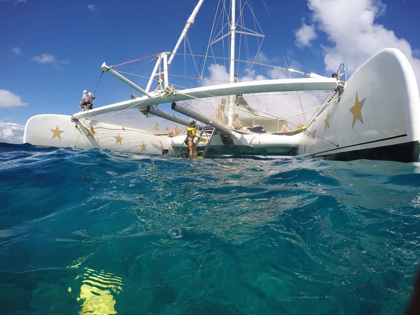 Sosua Catamaran Excursion - Pulling up the mainsail along the coast