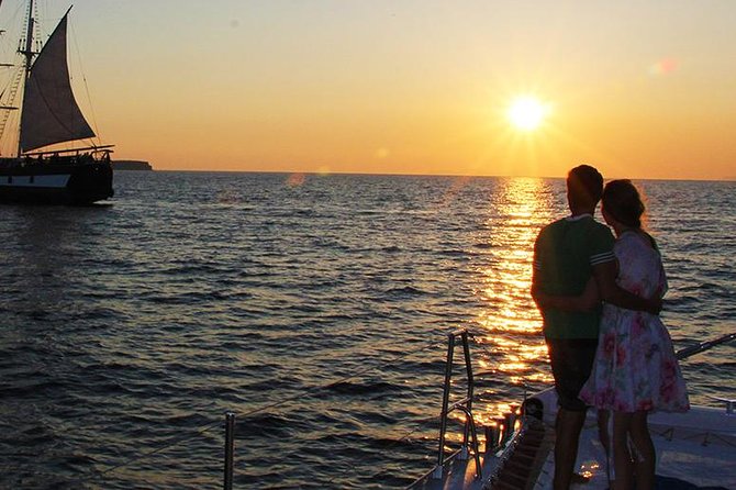 Sunset Sailing Catamaran Cruise in Santorini with BBQ and Drinks - Red Beach from the water